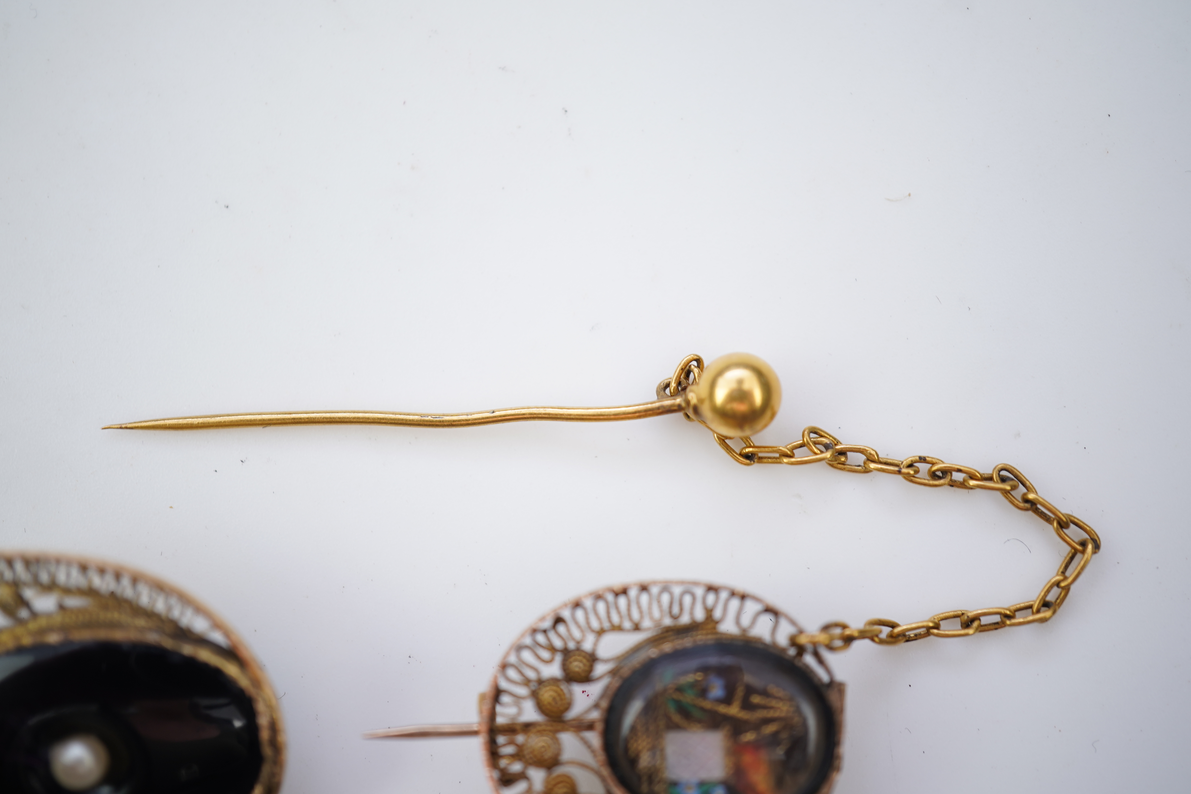 A collection of shell cameo brooches, comprising: a cameo depicting Bacchus, in a gold mount in the Archaeological Revival style, decorated with rope twist and a twisted knife wire border, length 4.4cm; together with sev
